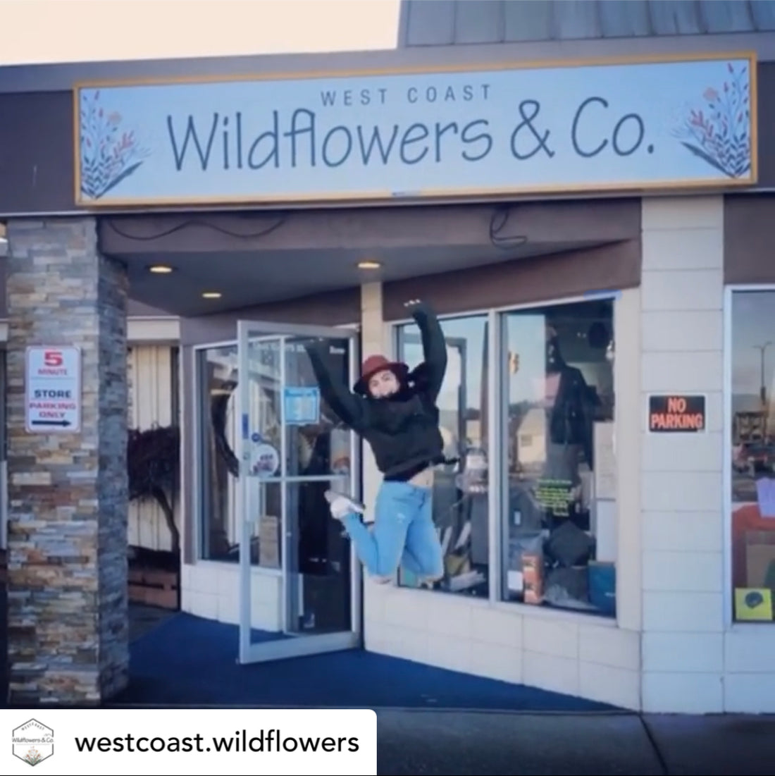 Alissa jumping in excitement in front of the Wildflowers & Co. shop